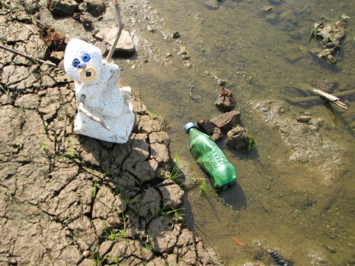 Kneeling figure with plastic bottle, 7/2010