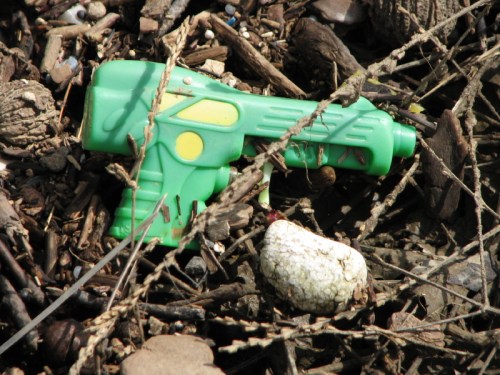 short-handled green plastic water pistol