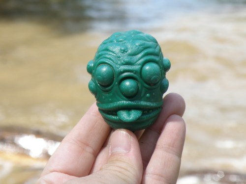 green toy character head sticking out its tongue, July 2013