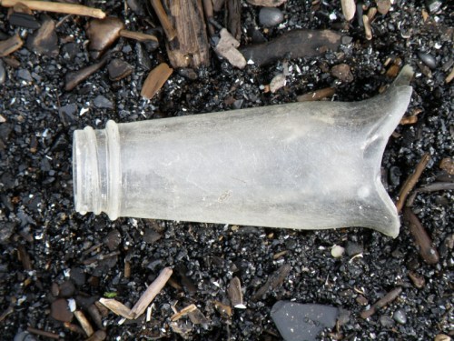 glass bottleneck against coal gravel, 2013