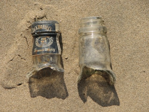 two glass bottlenecks on sand, 2013