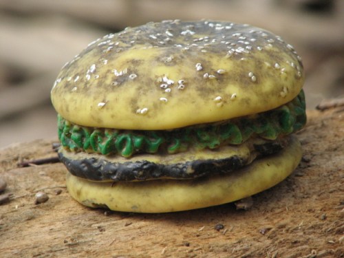 Gross cheeseburger with white poppy seeds and river patina