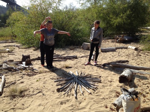 Park visitors interacting with my driftwood star, Falls of the Ohio, Oct. 2014