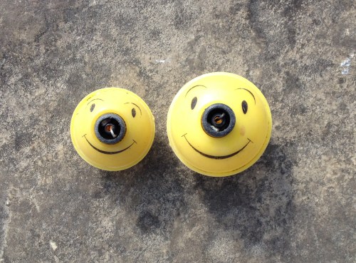 Two smiling face fishing floats from the Falls of the Ohio